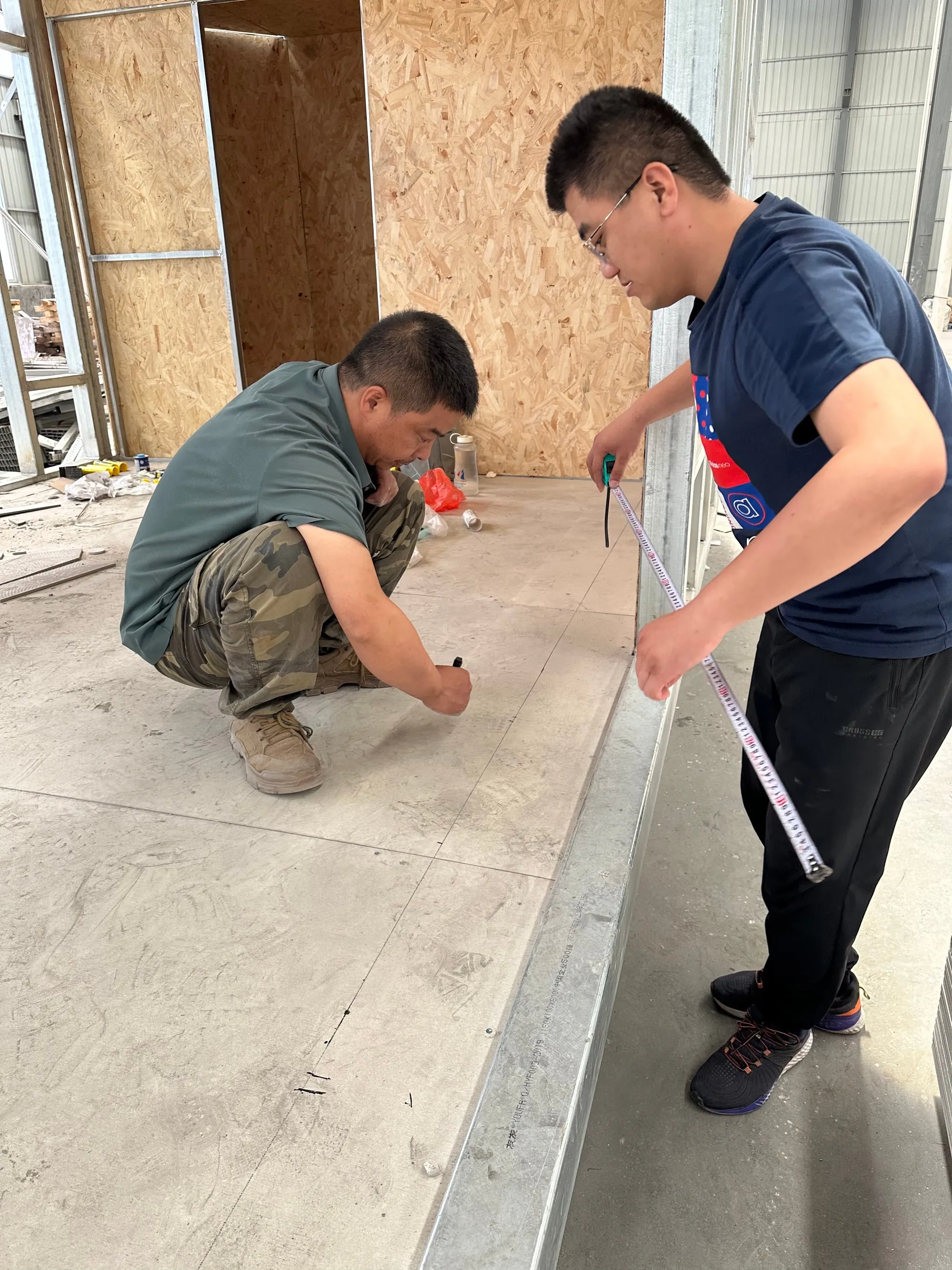 Two installers setting out ComfortScrim across a floor