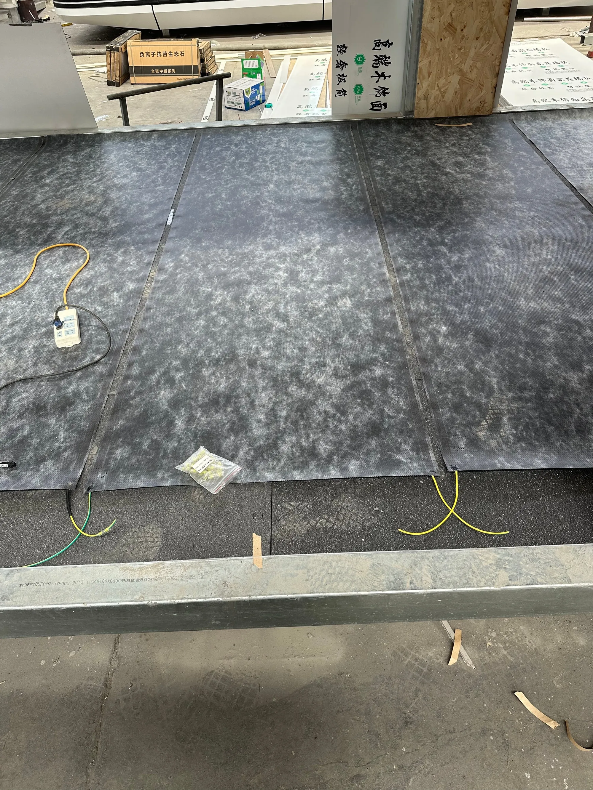 ComfortScrim on a floor with its low-voltage cabling run back to the supply