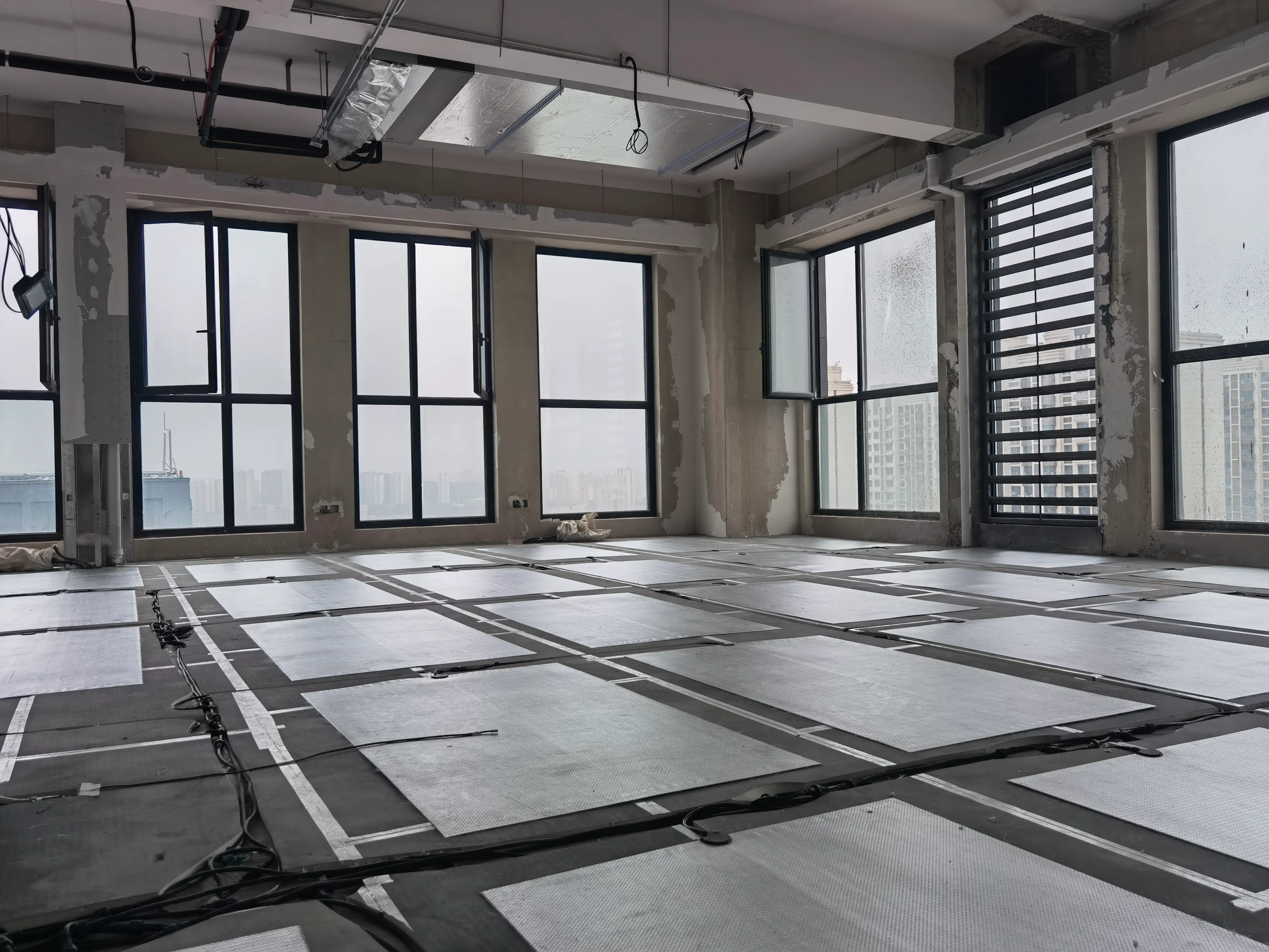 SafeTech EGS heating film rolled out across the office floor over insulation board