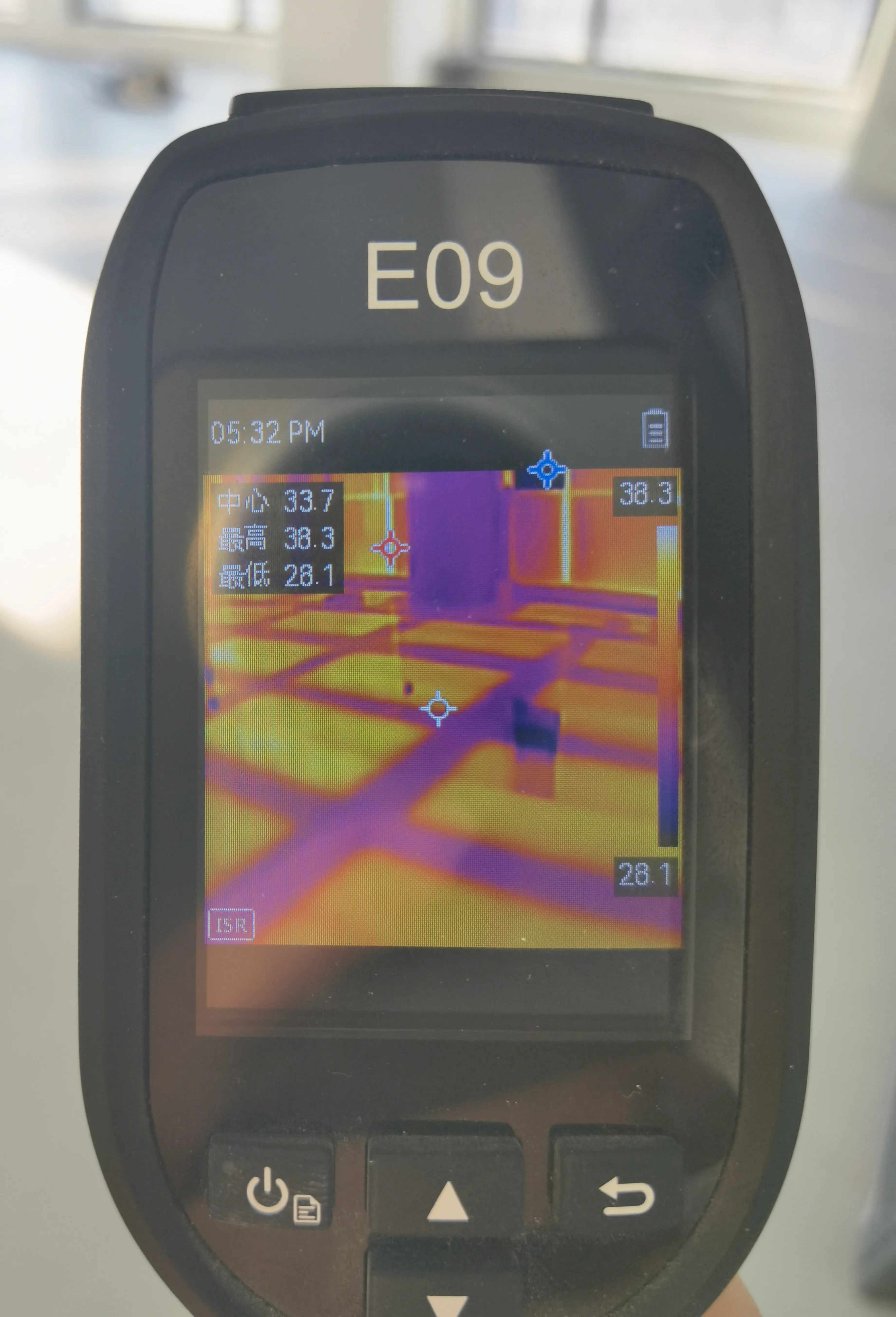 Handheld thermal camera showing SafeTech EGS heating strips warming evenly through the tiled floor