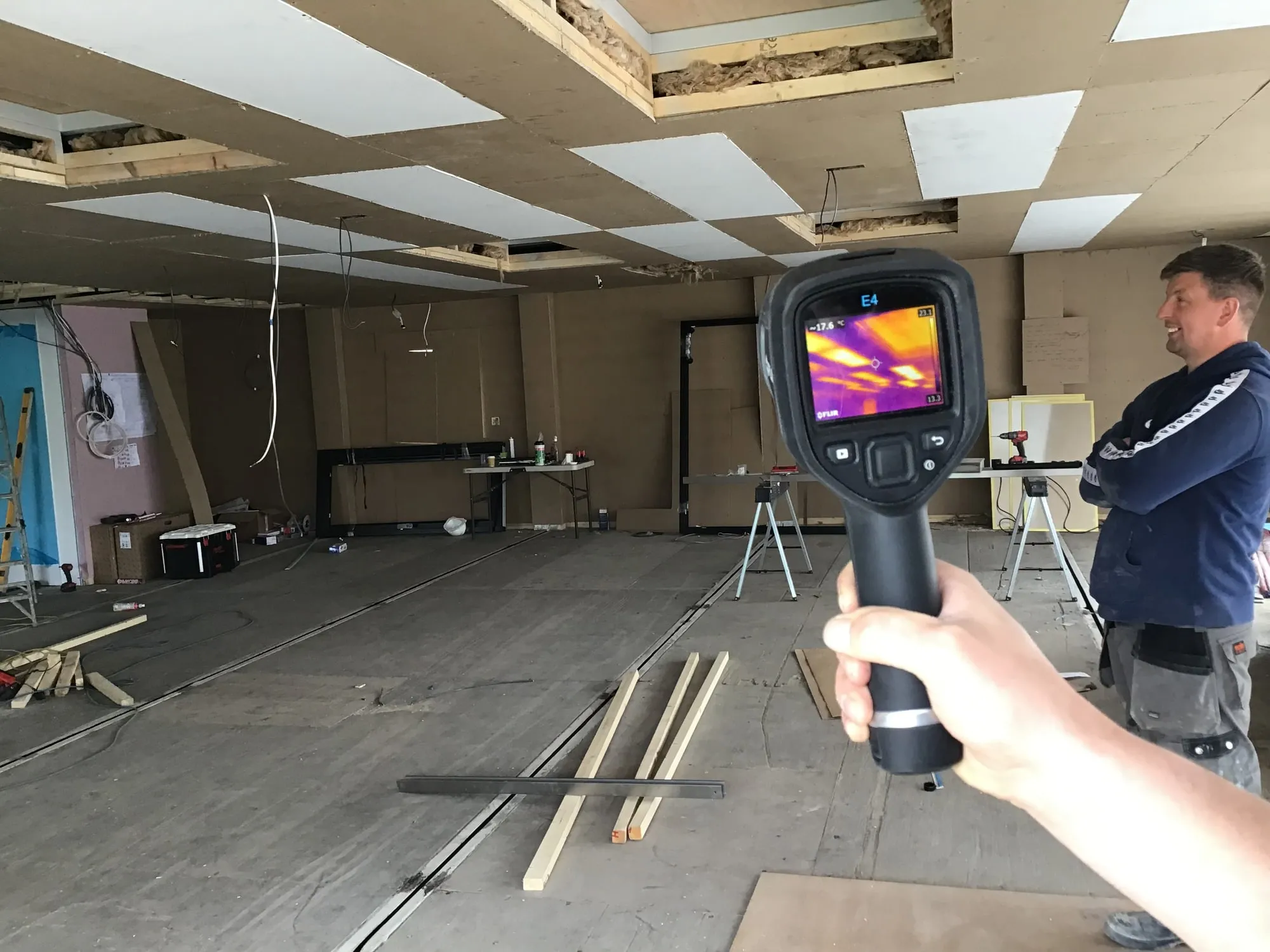 An engineer checking a finished ceiling with a thermal camera
