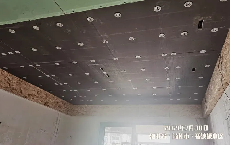 A ceiling with ComfortScrim fitted around downlight positions