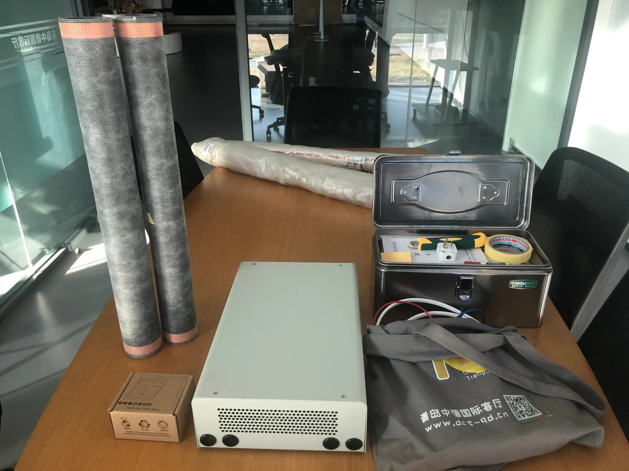 Rolls of ComfortScrim beside a Lamina Heat power supply unit and installation accessories